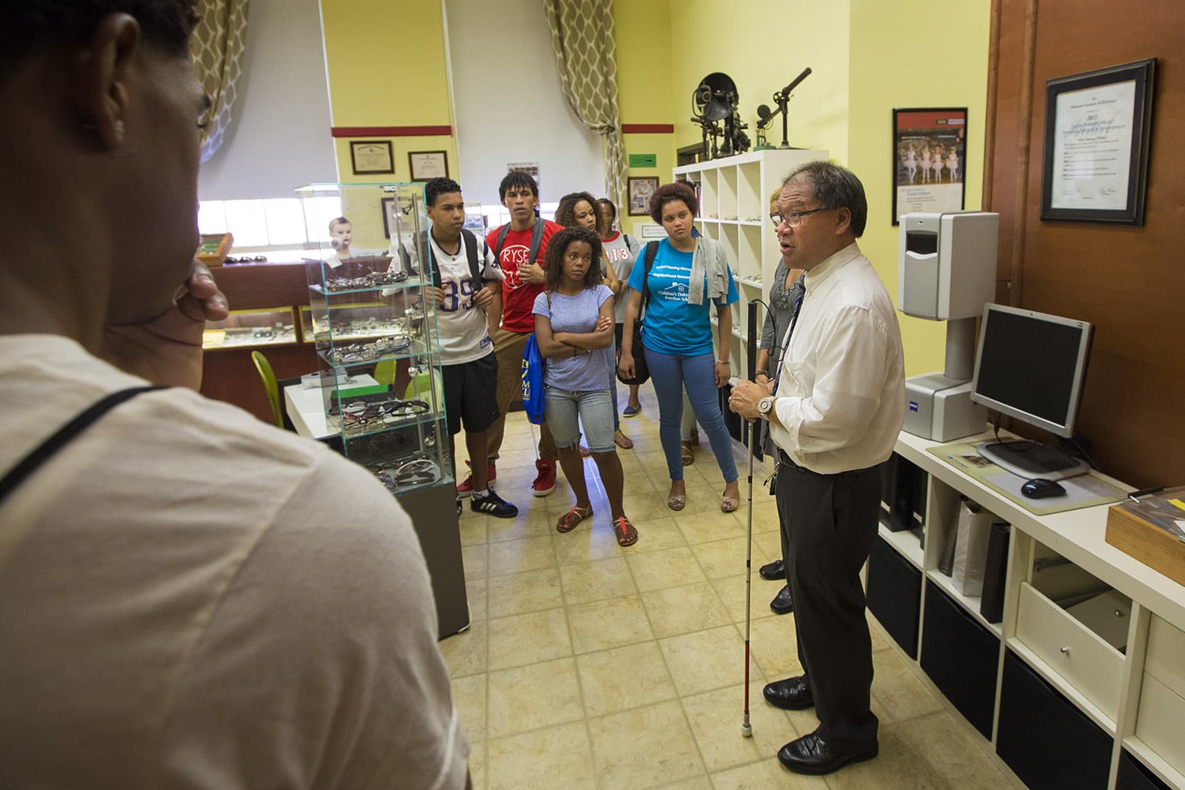 Professor Blair Wong speaks with a group of prospective students interested in the opticians program at Benjamin Franklin Technical Institute. (Jesse Costa/WBUR)