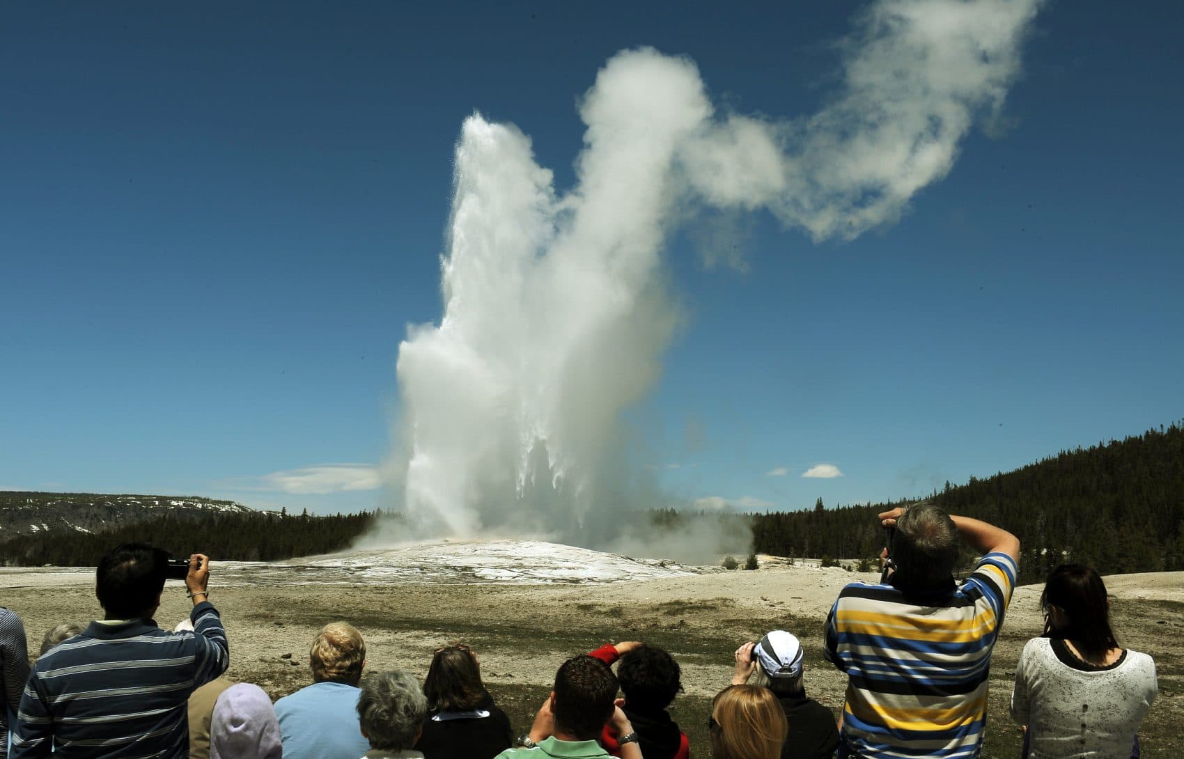 Tourists watch the &quot;Old Faithful&quot; geyser, which erupts on average every 90 minutes, at Yellowstone National Park in Wyoming on June 1, 2011. (Mark Ralston/AFP/Getty Images)
