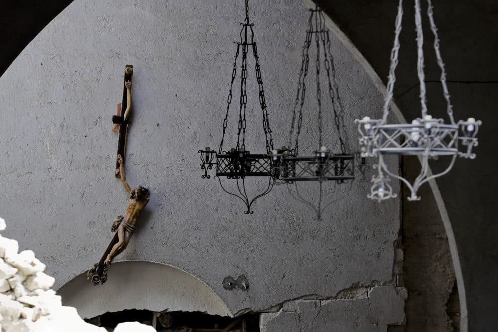 A broken crucifix hangs inside the damaged church of Santa Maria della Misericordia in Accumoli, Italy. (Andrew Medichini/AP)