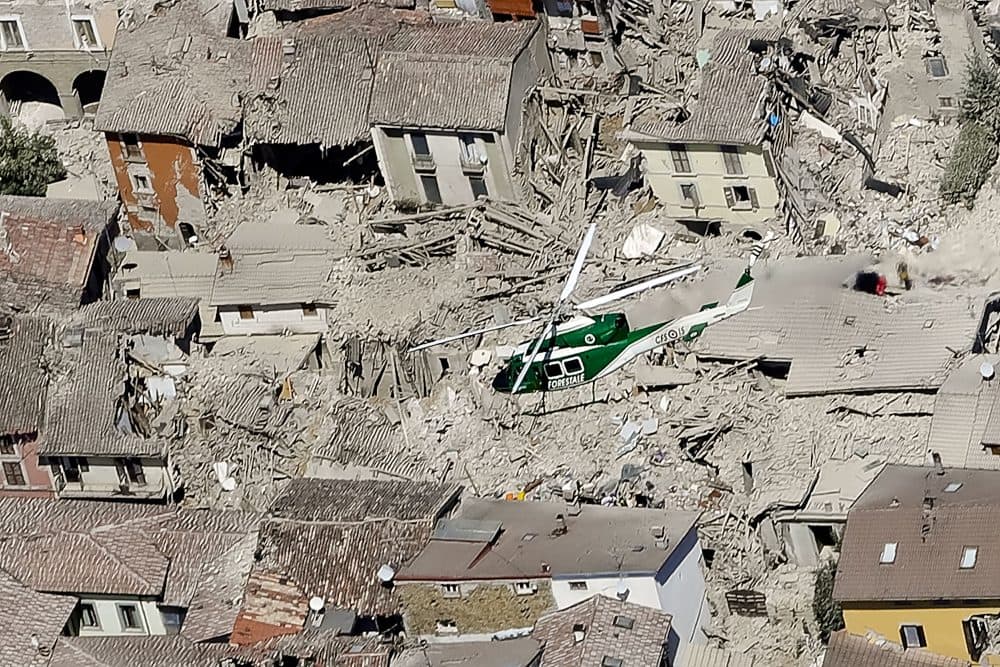 Rescuers search amid rubble following an earthquake in Amatrice in central Italy on Wednesday. (Gregorio Borgia/AP)