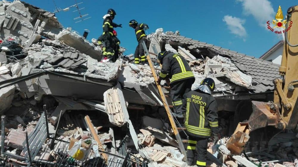 Firefighters search through debris of a collapsed building following an earthquake in Amatrice, Italy on Wednesday. (Italian Firefighters via AP)