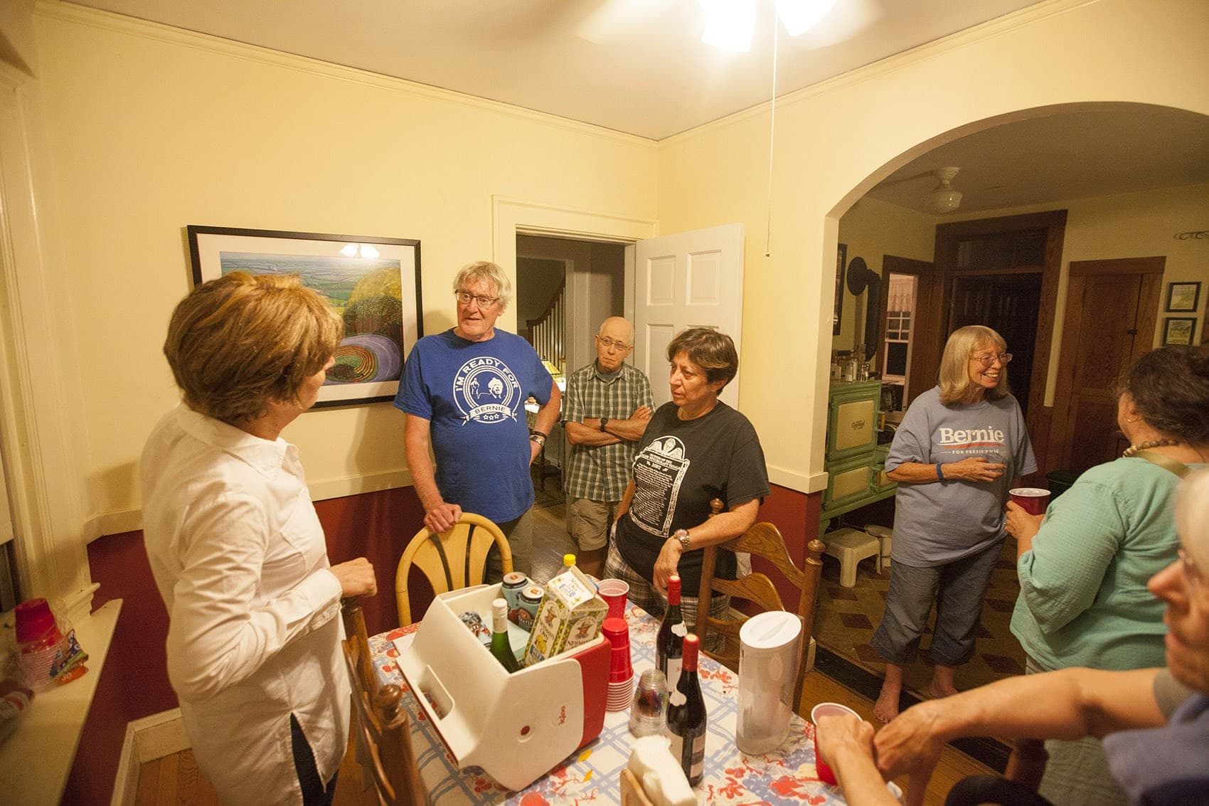 People gather at the home of Mary Brady and Monroe Heyman in Jamaica Plain as part of a series of national gatherings to watch the livestream of Sen. Bernie Sanders’ message to his supporters. (Joe Difazio for WBUR)