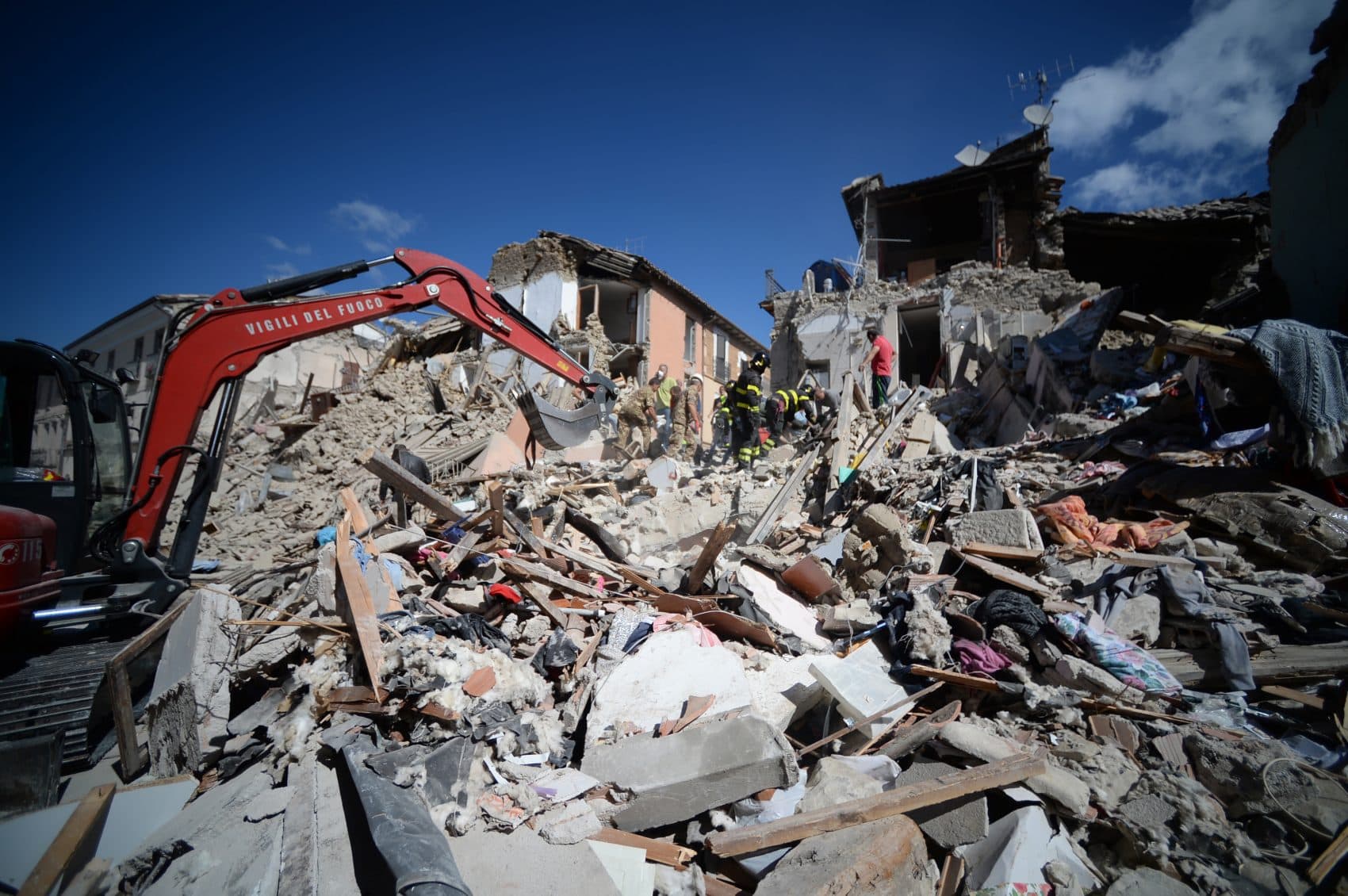 Rescuers and firemen inspect the rubble of buildings in Amatrice, Italy on Aug. 24, 2016 after a powerful earthquake rocked central Italy. (Filippo Monteforte/AFP/Getty Images)