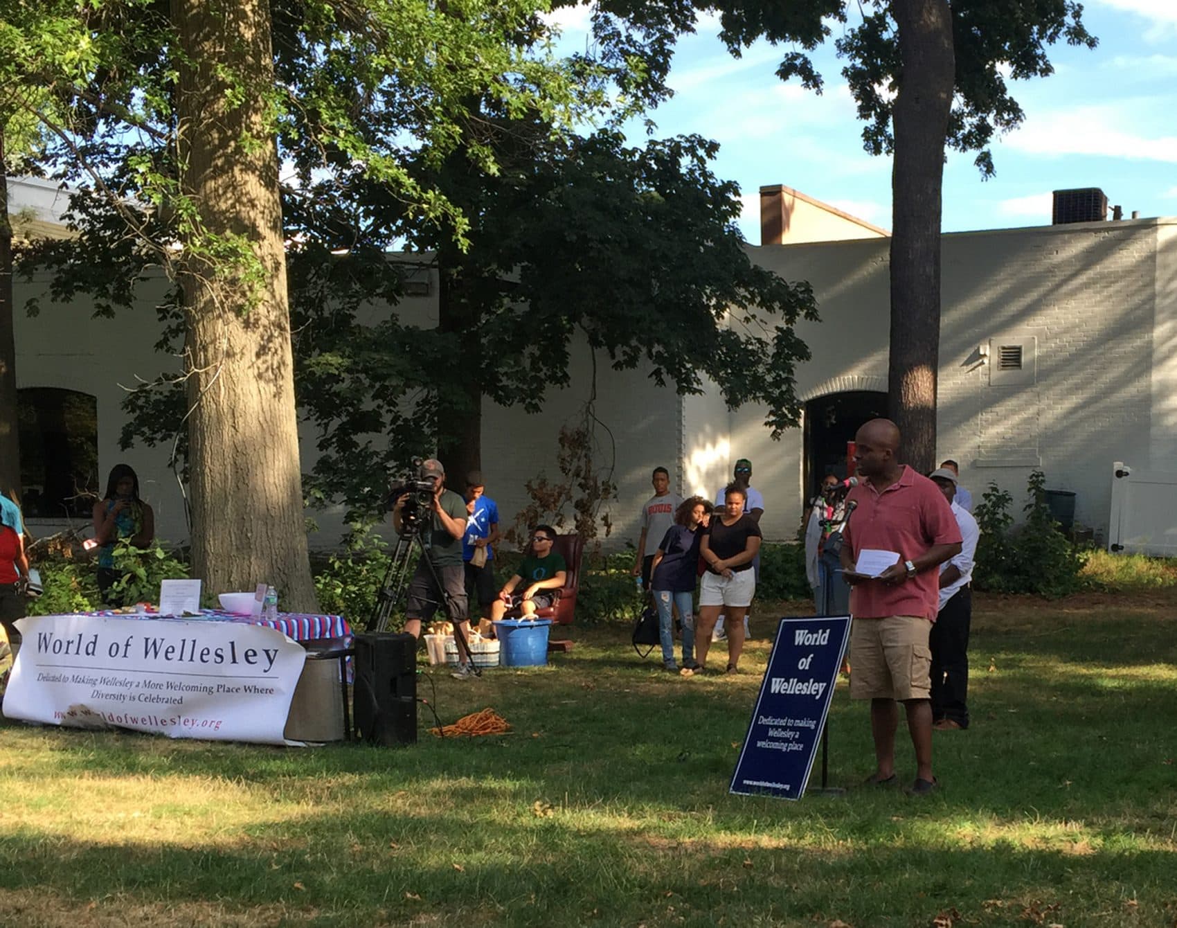 Tendai Musikavanhu speaks at a gathering in Wellesley to address racism targeted at his son, a Wellesley high school student. (Fred Thys/WBUR)