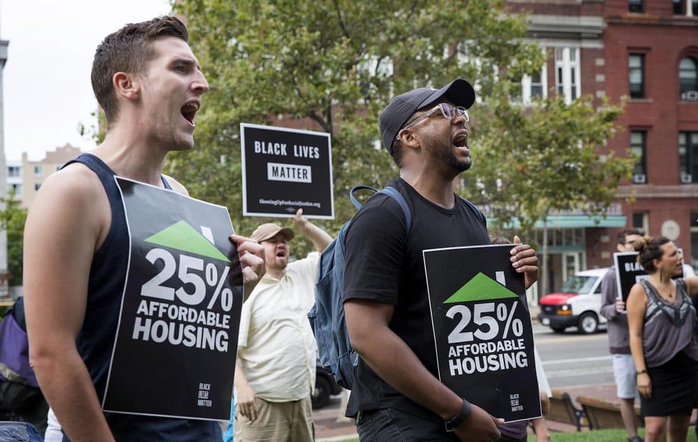 Protesters hold up signs that read &quot;25% affordable housing.&quot; (Robin Lubbock/WBUR)