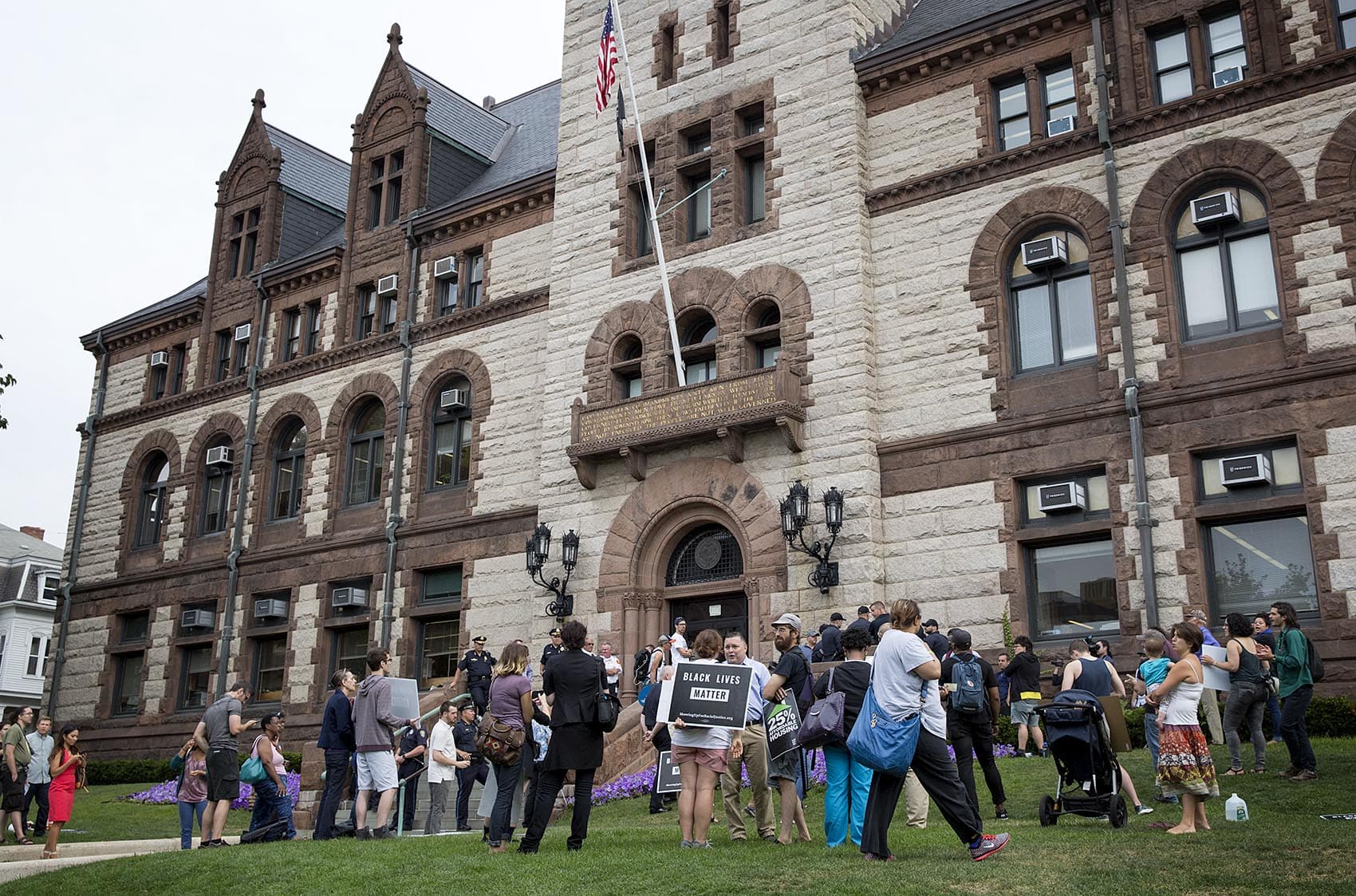 Protesters gather outside Cambridge City Hall Wednesday morning. (Robin Lubbock/WBUR)