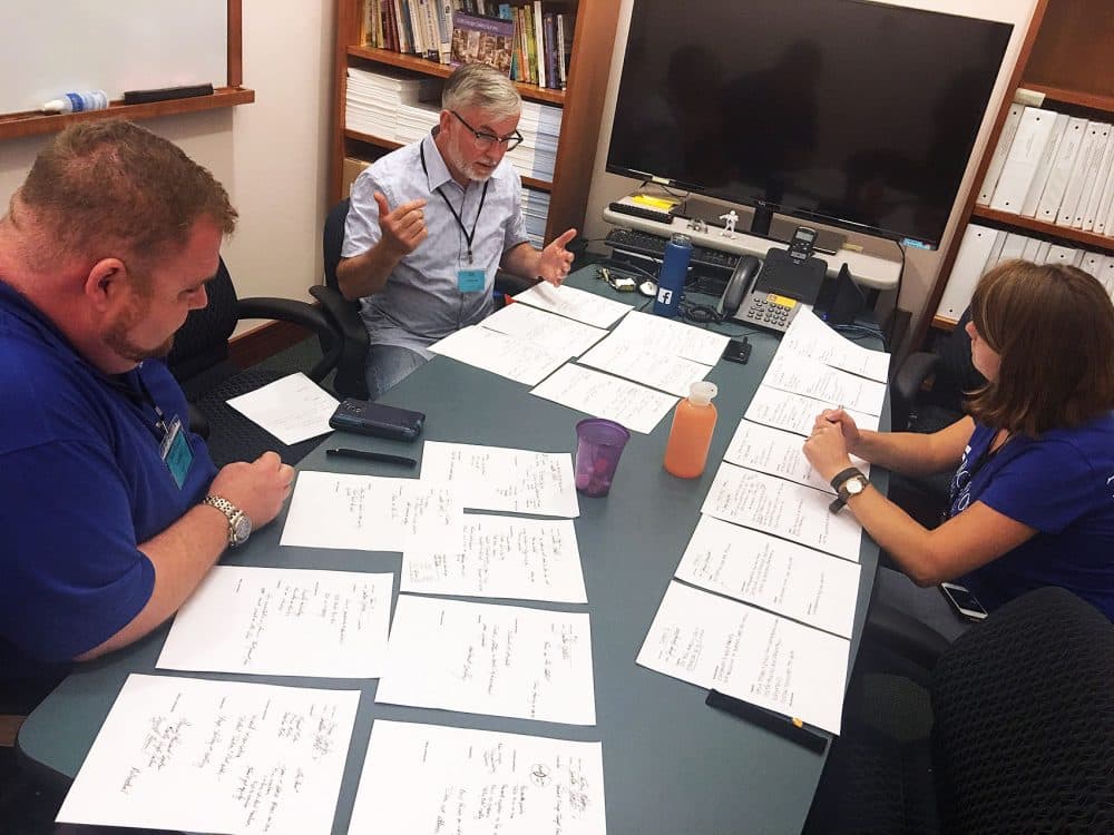 Deliberations over hackathon ideas. From left: Jonathan Steketee, Boston Public Schools transportation director; Bill Gribbons, program director, Human Factors in Information Design, Bentley University Graduate School of Business; and Jaclyn Youngblood, co-lead, BPS Experience Lab (Tonya Mosley/WBUR)