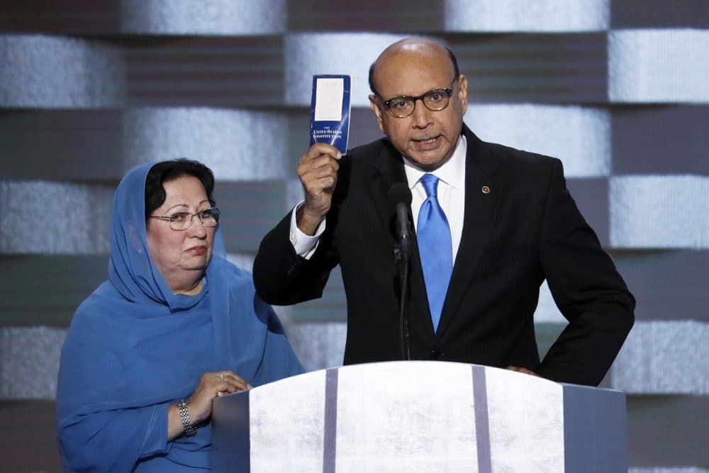 Khizr Khan, father of fallen U.S. Army Capt. Humayun Khan, holds up a copy of the Constitution alongside his wife as he addresses the Democratic National Convention Thursday. (J. Scott Applewhite/AP)