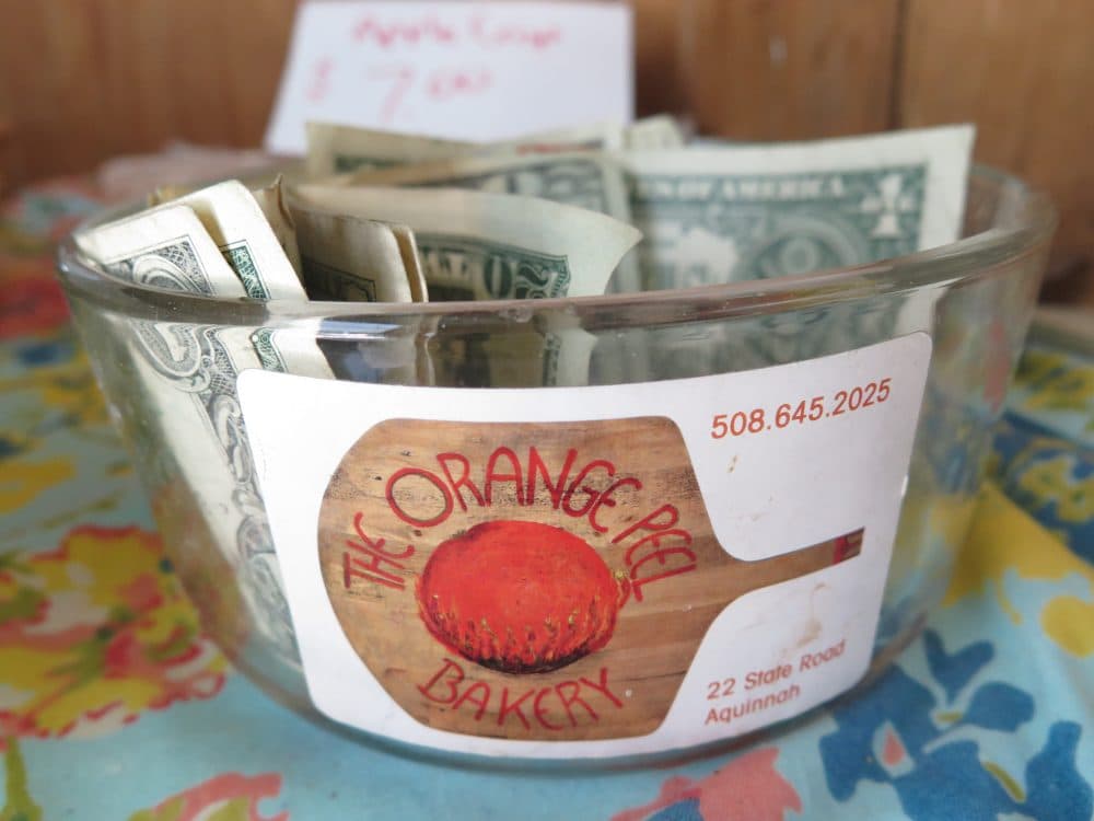Orange Peel Bakery operates on a “help yourself” honor system with a money bowl. (Andrea Shea/WBUR)