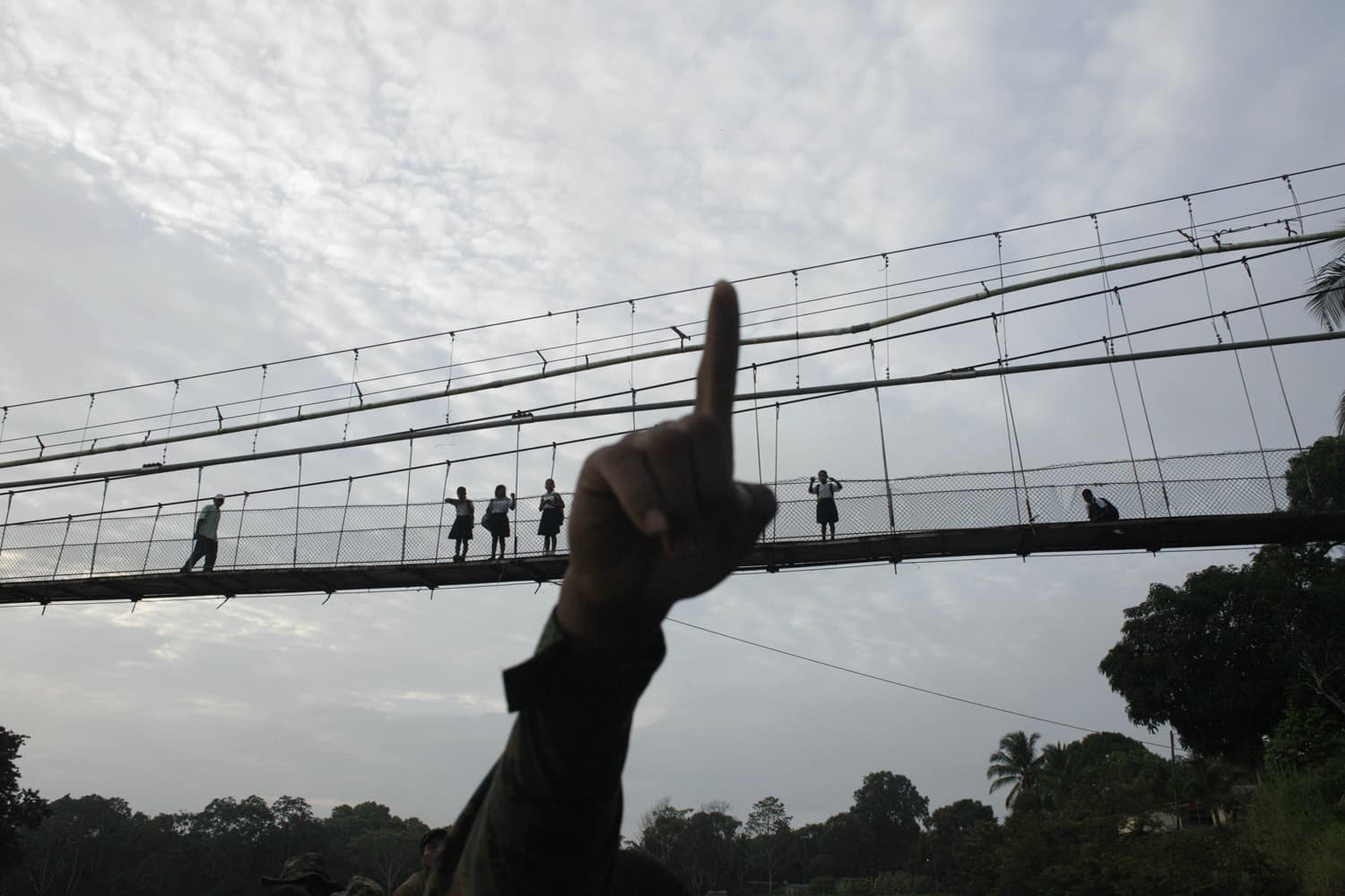 In this June 19, 2012 photo, a Panama border police officer points as he begins to patrol in the Darien province, on the border with Colombia, in Yaviza, Panama. (Arnulfo Franco/AP)