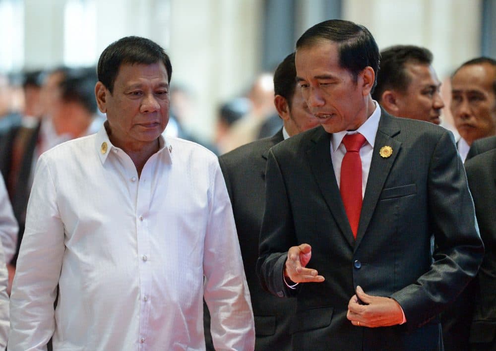 Philippine President Rodrigo Duterte (left) listens to Indonesia's President Joko Widodo while heading for a plenary session during the Association of Southeast Asian Nations (ASEAN) Summit in Vientiane on Sept. 6, 2016. (Roslan Rahman/AFP/Getty Images)