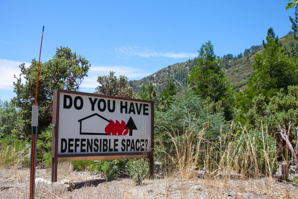 Property owners living close to wilderness areas must remain vigilant; embers can also travel large distances and ignite properties within housing tracts. (Susanica Tam for KPCC)