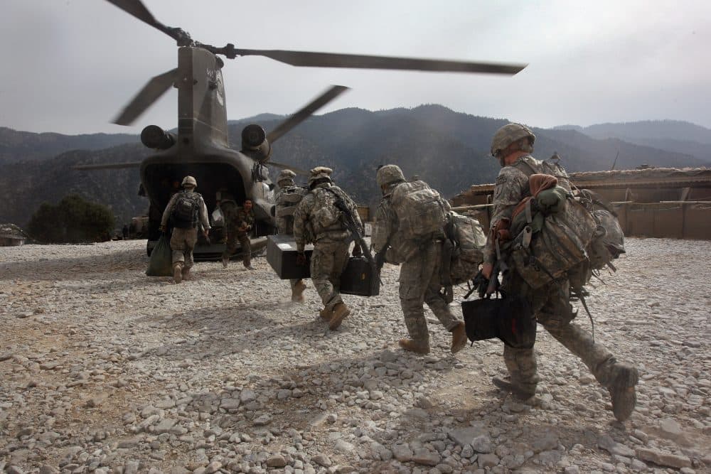 U.S. soldiers board an Army Chinook transport helicopter after it brought fresh soldiers and supplies to the Korengal Outpost on Oct. 27, 2008, in the Korengal Valley, Afghanistan. (John Moore/Getty Images)