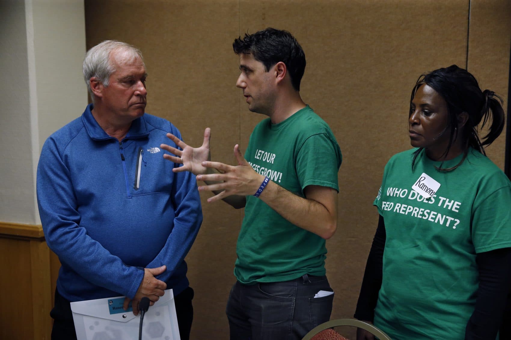 Eric Rosengren, left, the president of the Federal Reserve Bank of Boston, talks with Ady Barkan, campaign director for Fed Up, before the opening night reception at the annual invitation-only conference of central bankers from around the world. (Brennan Linsley/AP)
