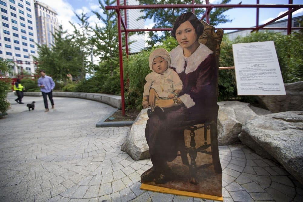 &quot;Mother and Baby&quot; sits at the edge of Chinatown Park, one of artist Wen-Ti Tsen's life-size portraits of residents illustrating the neighborhood's long history. (Jesse Costa/WBUR)