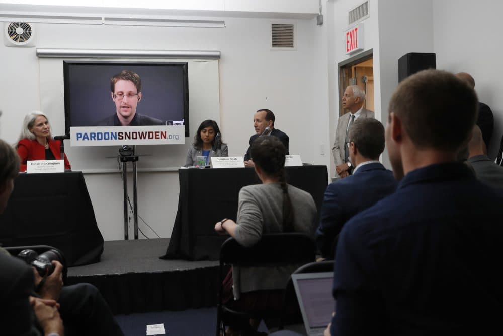 Edward Snowden is seen on a television screen via video link from Moscow during a news conference to call upon President Barack Obama to pardon Snowden before he leaves office on Sept. 14, 2016, in New York. (Mary Altaffer/AP)