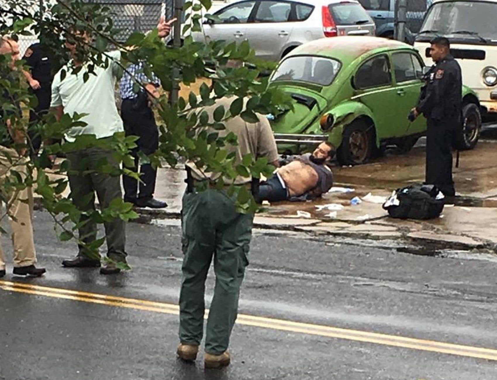Ahmad Khan Rahami is taken into custody after a shootout with police Monday, Sept. 19, 2016, in Linden, N.J. Rahami was wanted for questioning in the bombings that rocked the Chelsea neighborhood of New York and the New Jersey shore town of Seaside Park. (Moshe Weiss/AP).