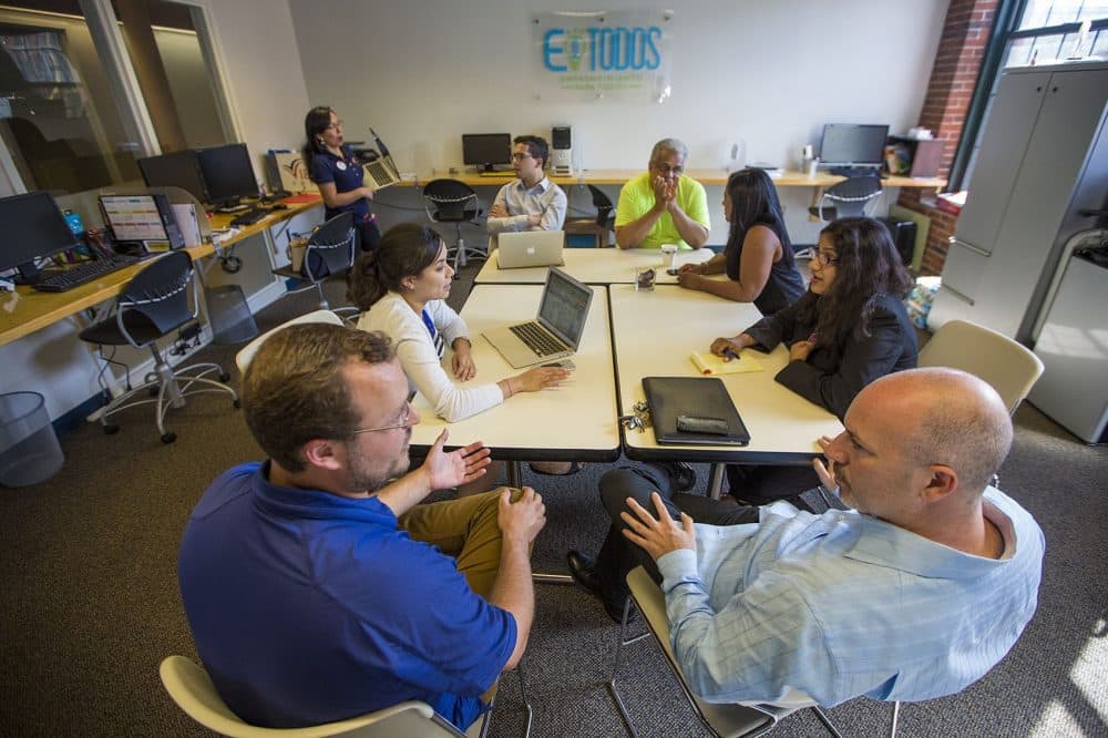 Entreprenuers, Mentors and staff collaborate in the Entreprenuership for All co-working space in Lawrence. (Jesse Costa/WBUR)