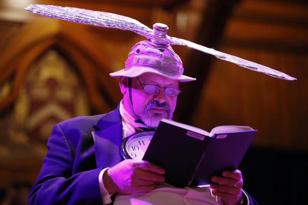 Majordomo Gary Dryfoos reads on stage before the Ig Nobel award ceremonies at Harvard on Thursday. (Michael Dwyer/AP)