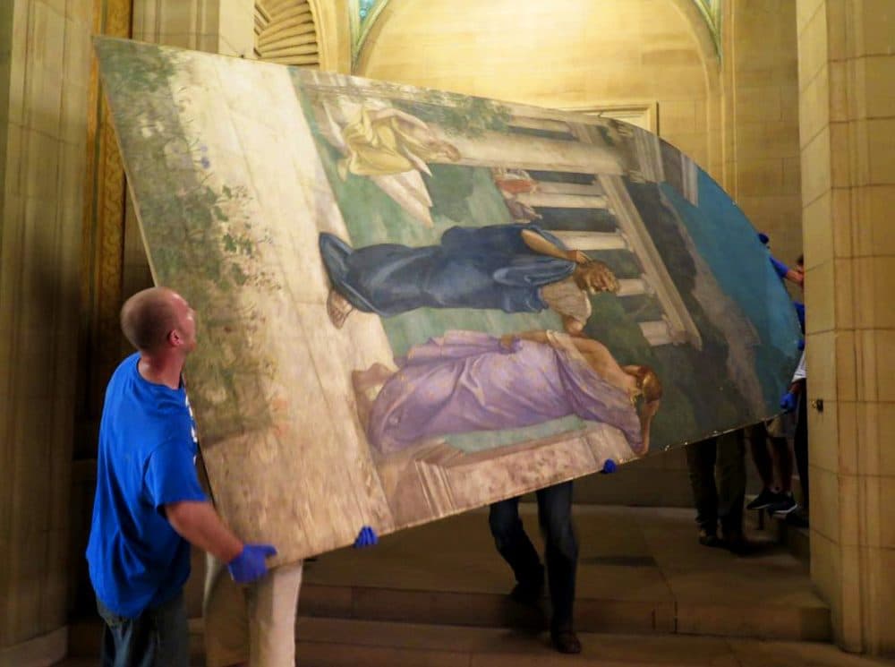 Gloved workers slowly and carefully move the “Philosophy” panel, created by 19th century French muralist Pierre Puvis de Chavannes, in the Boston Public Library. (Andrea Shea/WBUR)