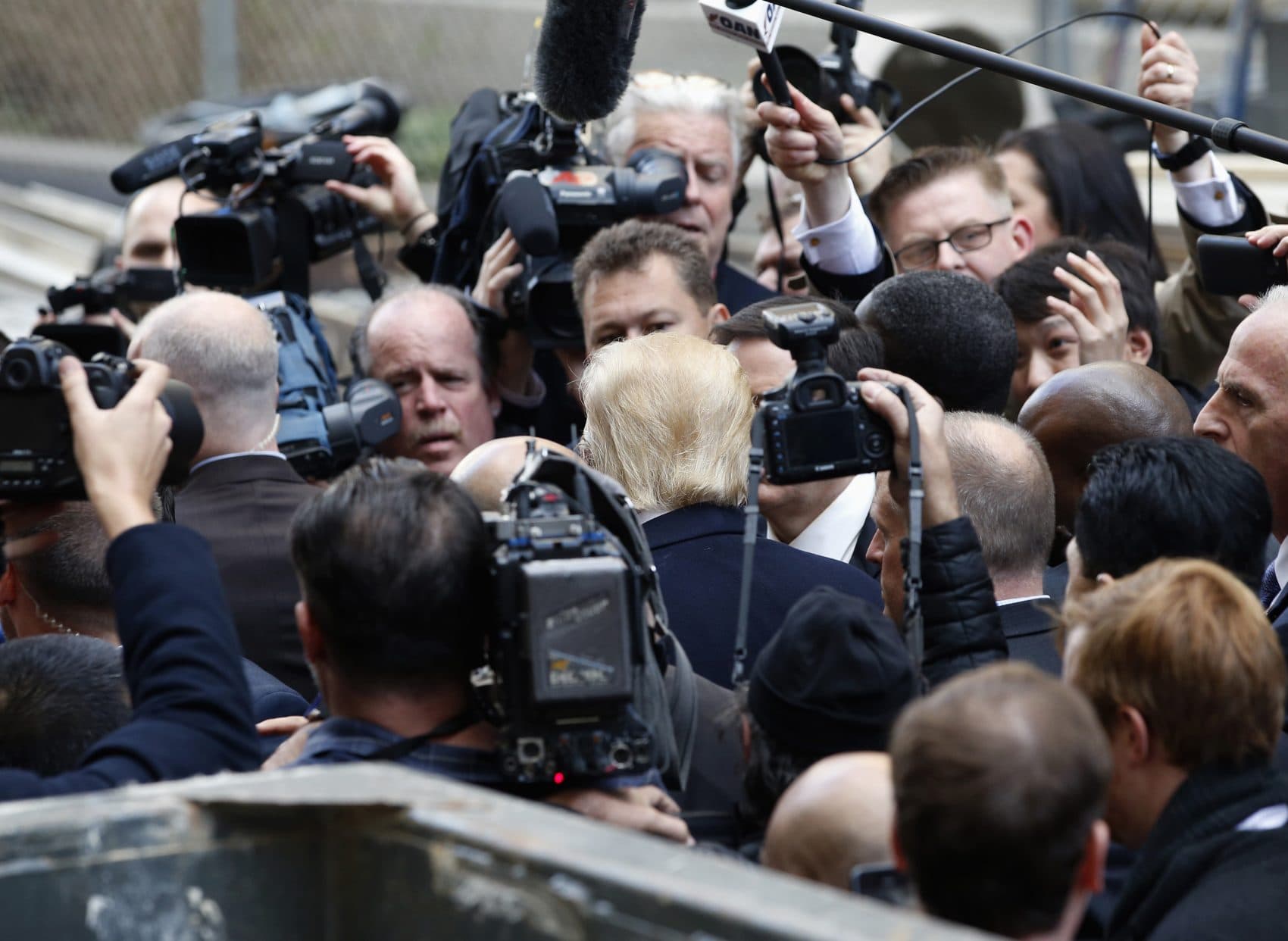 Republican presidential candidate Donald Trump, center, is surrounded by the media in Washington, Monday, March 21, 2016. (Alex Brandon/AP)
