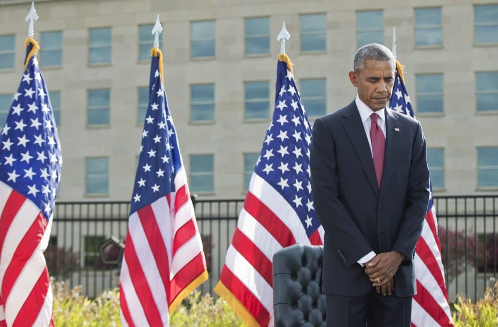 President Barack Obama bows as a moment of silence is observed during a memorial ceremony at the Pentagon in Washington to commemorate the 15th anniversary of the 9/11 terrorist attacks on Sunday. (Manuel Balce Ceneta/AP)