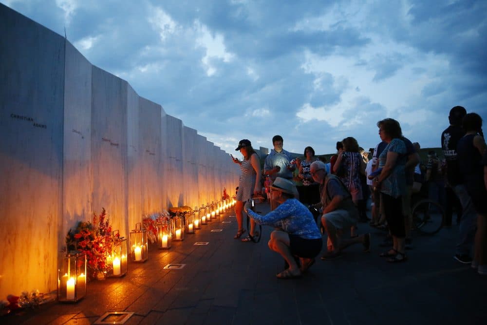 Candles in memory of the passengers and crew of Flight 93, are lit along the Wall of Names at the Flight 93 National Memorial in Shanksville, Pa., Saturday, Sept. 10, 2016. (Jared Wickerham/AP)