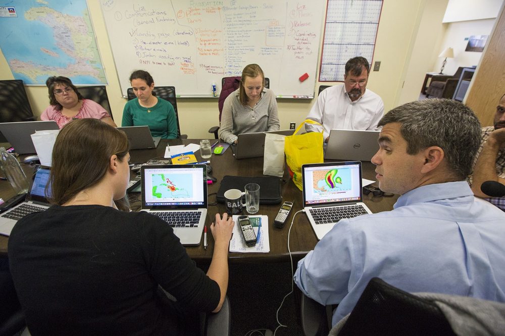 The St. Boniface Haiti Foundation team in Newton monitors the impact of Hurricane Matthew in southern Haiti. (Jesse Costa/WBUR)