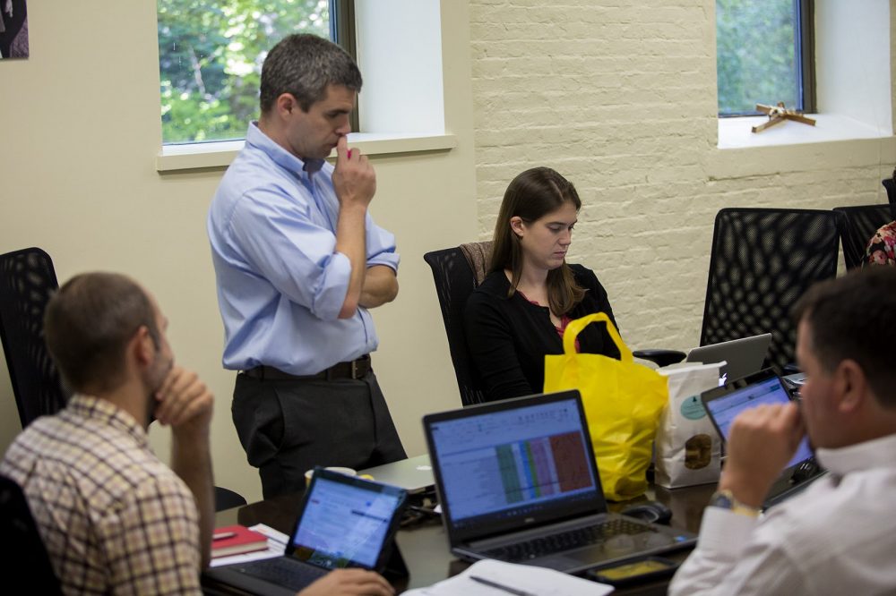 St. Boniface head Conor Shapiro and the rest of the U.S.-based staff listen to the latest conditions coming in via satellite communication from southern Haiti. (Jesse Costa/WBUR)