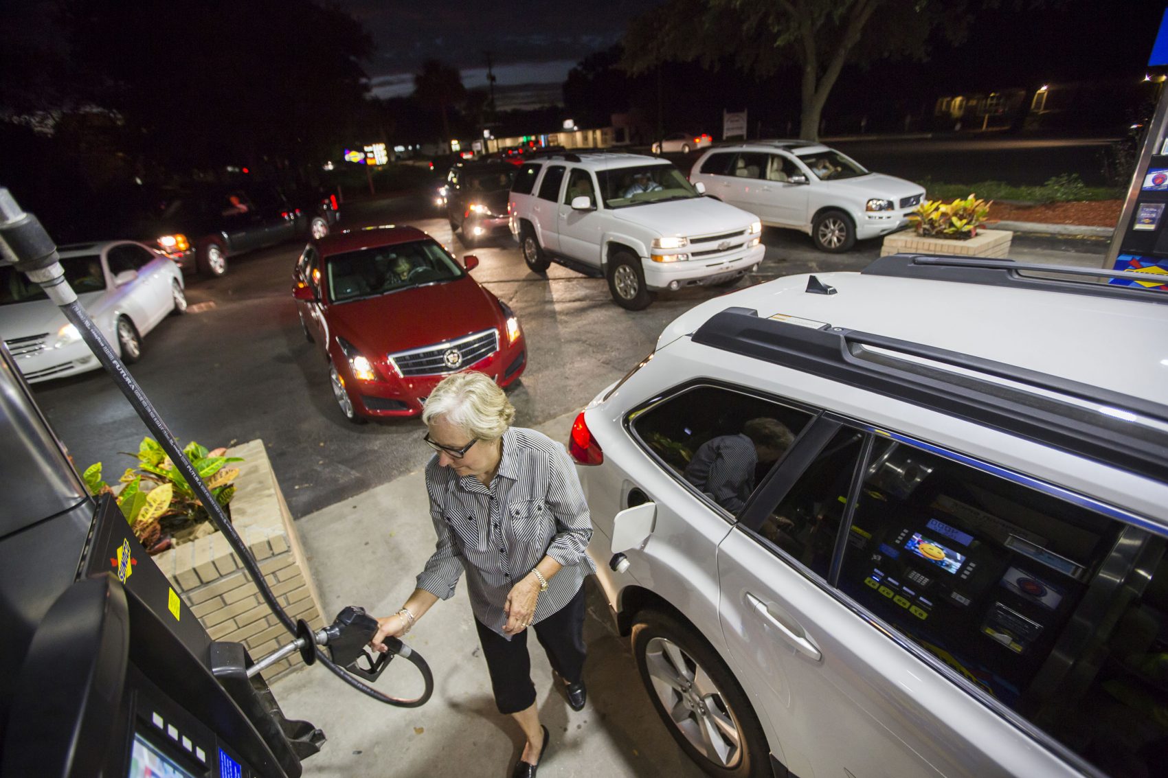 Gayle Brown fills up her car after waiting in line at a Sunoco gas station in Mt. Pleasant, S.C., Tuesday, Oct. 4, 2016 in advance of Hurricane Matthew. (Mic Smith/AP)