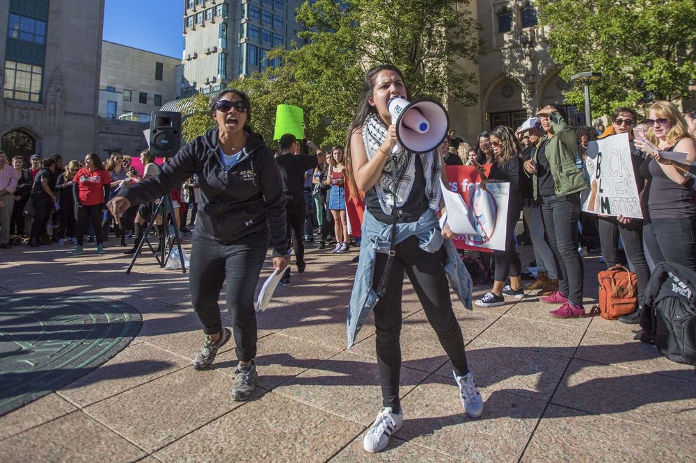 Boston University students shout into a microphone in the center of campus. (Jesse Costa/WBUR)