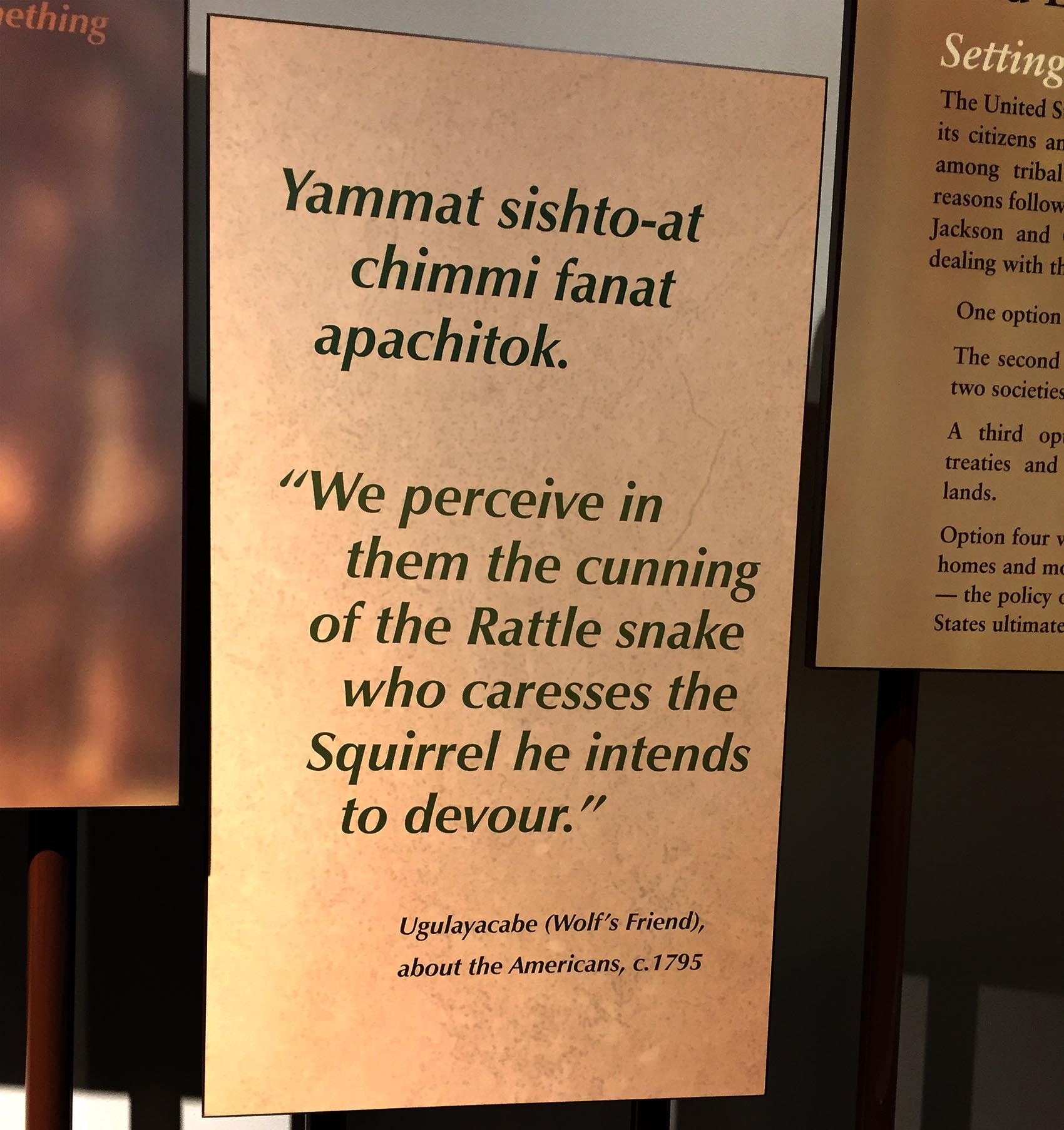 A bilingual sign in the Chikasha Poya Exhibit Center at the Chickasaw Cultural Center in Sulphur, Okla. (Karyn Miller-Medzon/Here &amp; Now)