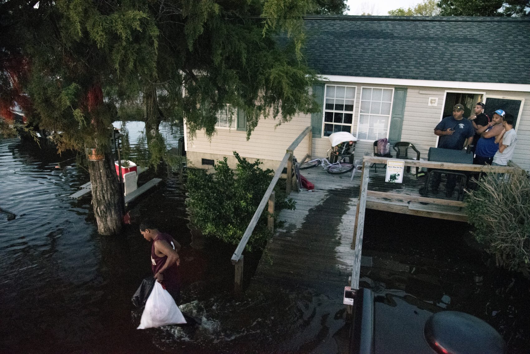 A man moves his belongings from his home that is surrounded by floodwaters caused by rain from Hurricane Matthew in Lumberton, N.C., Monday, Oct. 10, 2016. (Mike Spencer/AP)