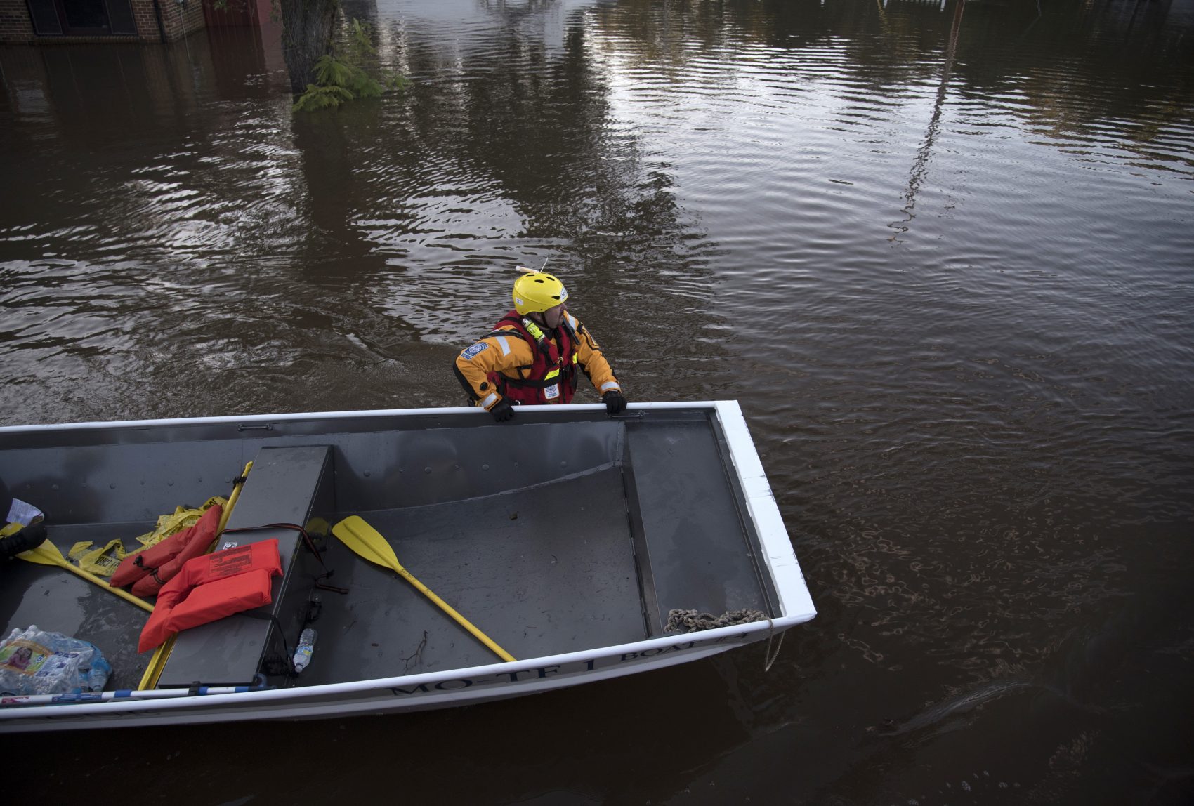 A swift water rescue team member guides a boat through floodwaters caused by rain from Hurricane Matthew in Lumberton, N.C., Monday, Oct. 10, 2016. (Mike Spencer/AP)