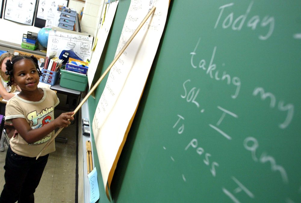 Marshawnda Overstreet, 9, points to the chalkboard during a lesson on reading Thursday, May 27, 2004, at B.C. Charles Elementary School in Newport News, Va. (Jason Hirschfeld/AP)