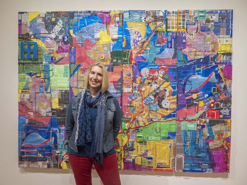 Lisa Barthelson stands in front of one of six pieces in the &quot;Plastic Imagination&quot; exhibition at the Fitchburg Art Museum. (Andrea Shea/WBUR)