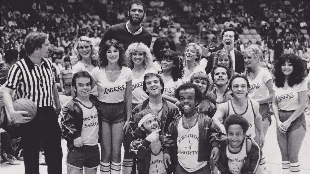 The Shorties in their first game versus the Laker Girls in December 1981. Kareem Abdul-Jabbar photobombs in the background, and Paula Abdul is featured in the center. (Andrew Bernstein)