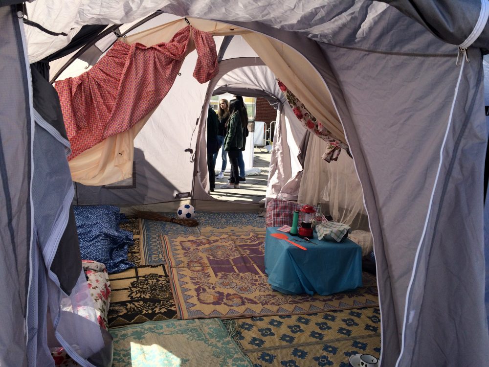 The exhibit includes common camping tents transformed into longer-term homes for refugees. (Qainat Khan for WBUR)