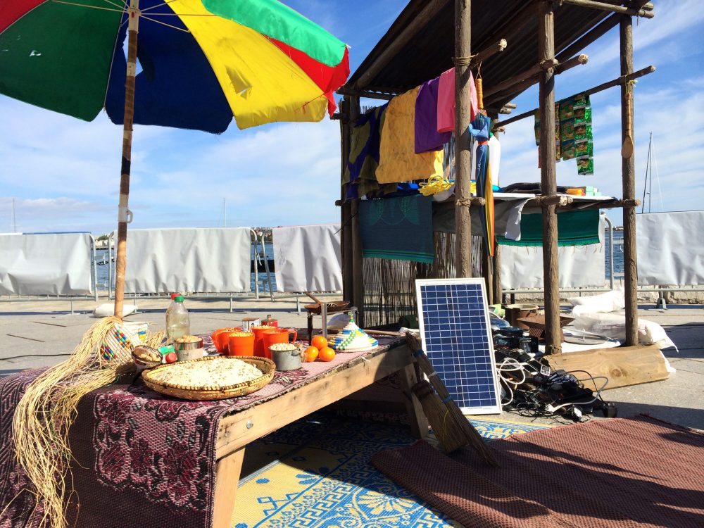 A makeshift market as seen, set up at Long Wharf in Boston. The market and charging stations are common scenes in refugee camps, the Doctors Without Borders volunteers say. (Qainat Khan for WBUR)