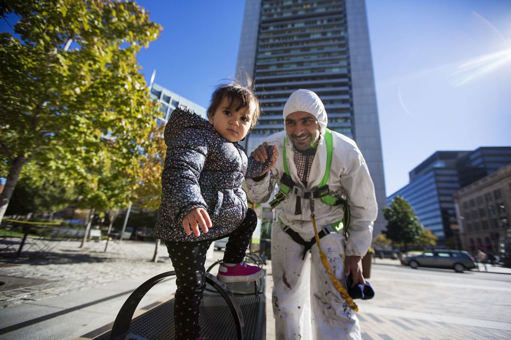 Mehdi Ghadyanloo poses with his daughter, Golsa, in Dewey Square. (Jesse Costa/WBUR) 