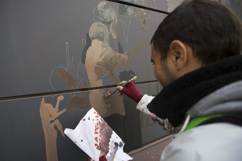 Ghadyanloo at work on the mural Thursday, Oct. 27. (Jesse Costa/WBUR)