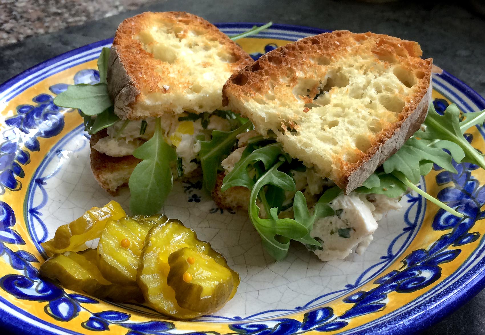 Kathy's chicken salad sandwich with arugula and pickles. (Kathy Gunst for Here &amp; Now)