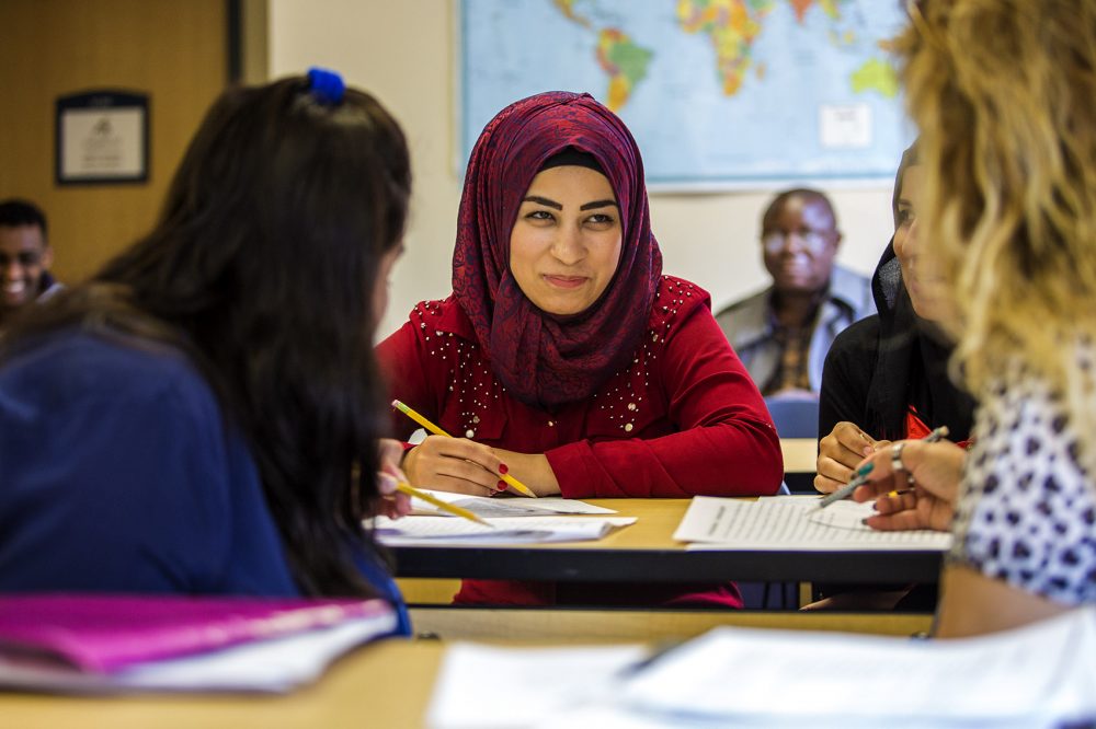 Zainab Abdo speaks with other students in an English for Speakers of Other Languages (ESOL) class at INNE in Lowell. (Jesse Costa/WBUR)