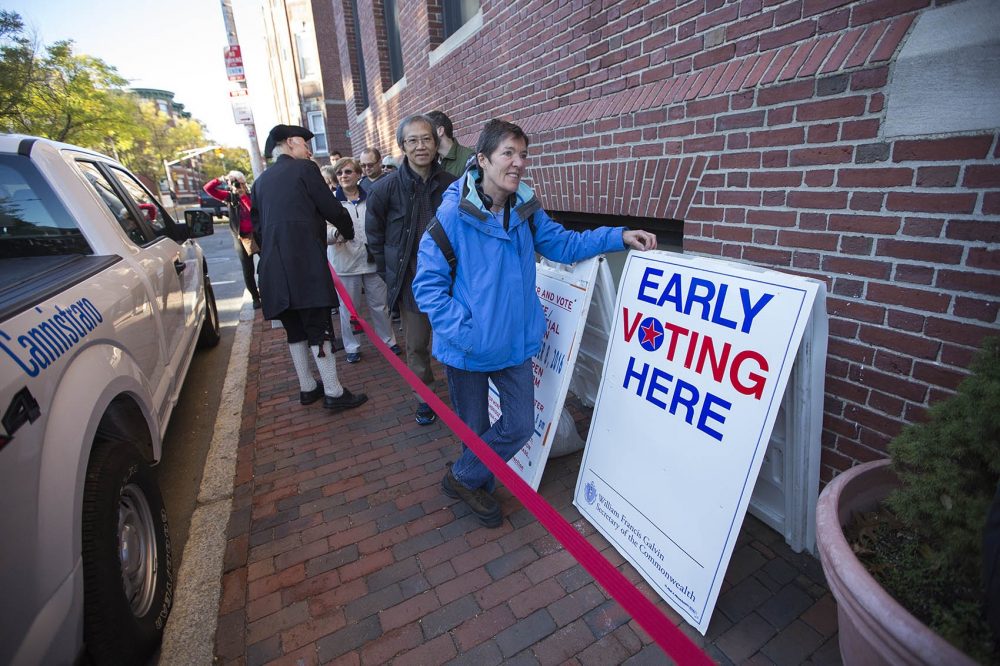 Cambridge voters wait in line on Inman Street to cast their ballots early on Monday, the first day of early voting in the state. (Jesse Costa/WBUR)