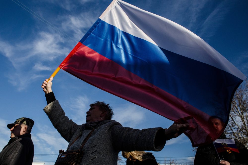 Crimeans wave Russian flags as they celebrate the first anniversary of the referendum on March 16, 2015 in Sevastopol, Crimea. (Alexander Aksakov/Getty Images)