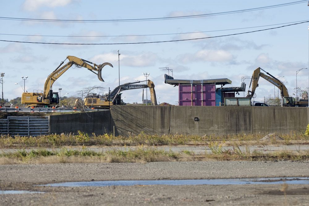 Contractors tear down one of the Allston toll booth houses along the Mass Pike. (Jesse Costa/WBUR)
