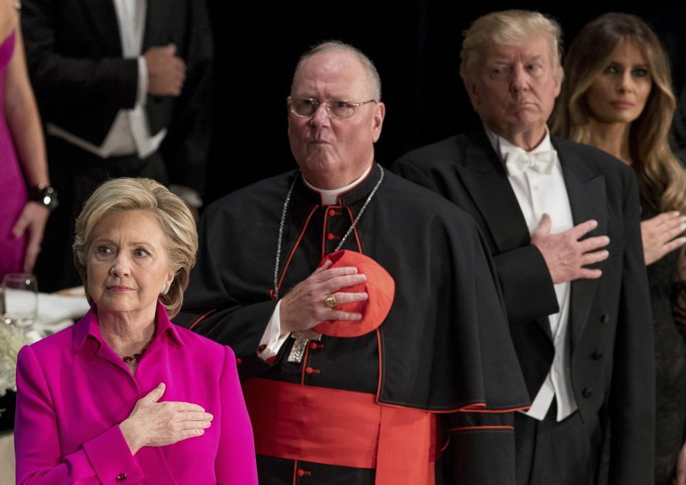 From left, Democratic presidential candidate Hillary Clinton, Cardinal Timothy Dolan, Archbishop of New York; Republican presidential candidate Donald Trump, and his wife Melania Trump, stand for the National Anthem at the 71st annual Alfred E. Smith Memorial Foundation Dinner, a charity gala organized by the Archdiocese of New York, Thursday, Oct. 20, 2016, at the Waldorf Astoria hotel in New York. (Andrew Harnik/AP)