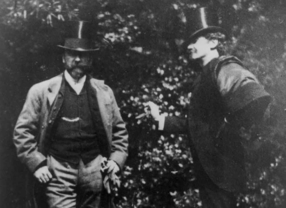 A portrait of artists William Merritt Chase and James Abbott McNeill Whistler standing in a yard around 1885. (Courtesy Library of Congress)