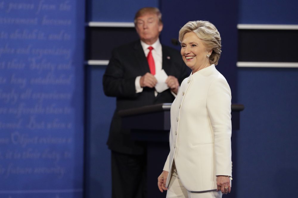Hillary Clinton walks toward the audience as Donald Trump stands behind his podium after the third presidential debate, Oct. 19, 2016. (John Locher/AP)