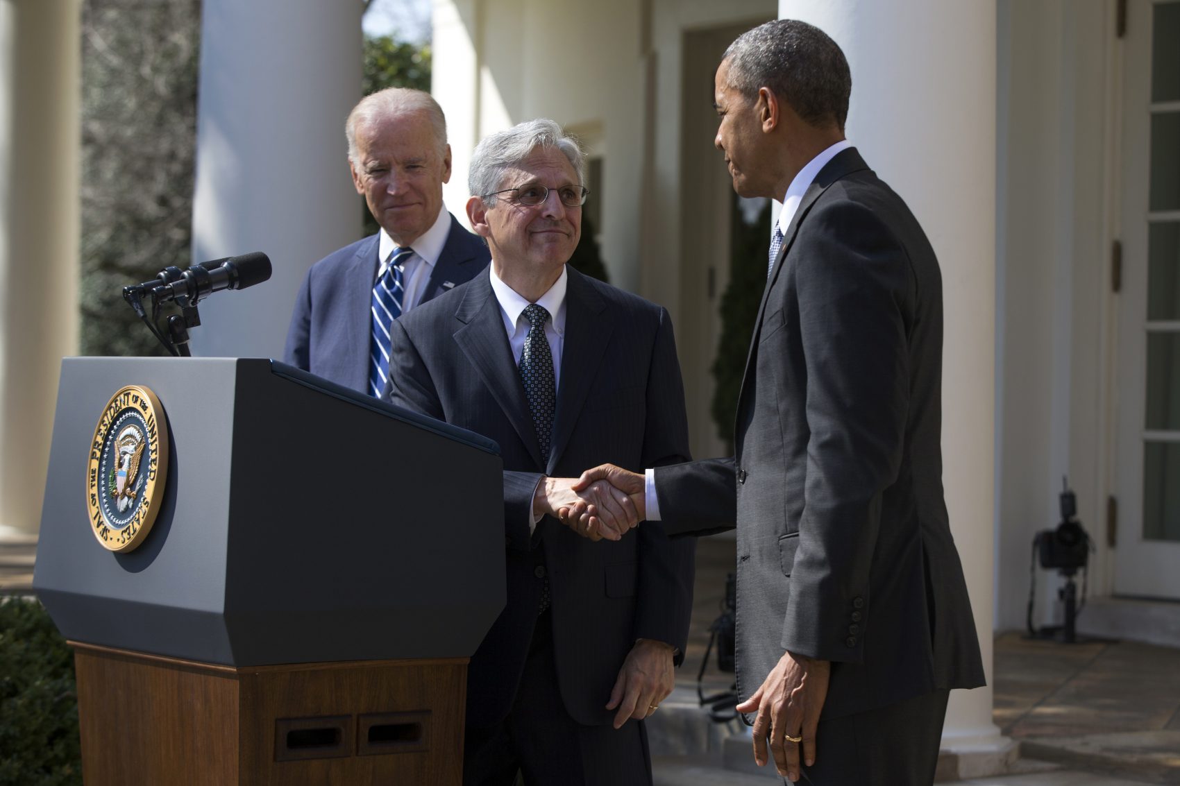 Federal appeals court Judge Merrick Garland, center, shakes hands with President Obama, right, as Vice President Joe Biden watches during his introduction as Obama's nominee for the Supreme Court in the Rose Garden of the White House on March 16. (Evan Vucci/AP)